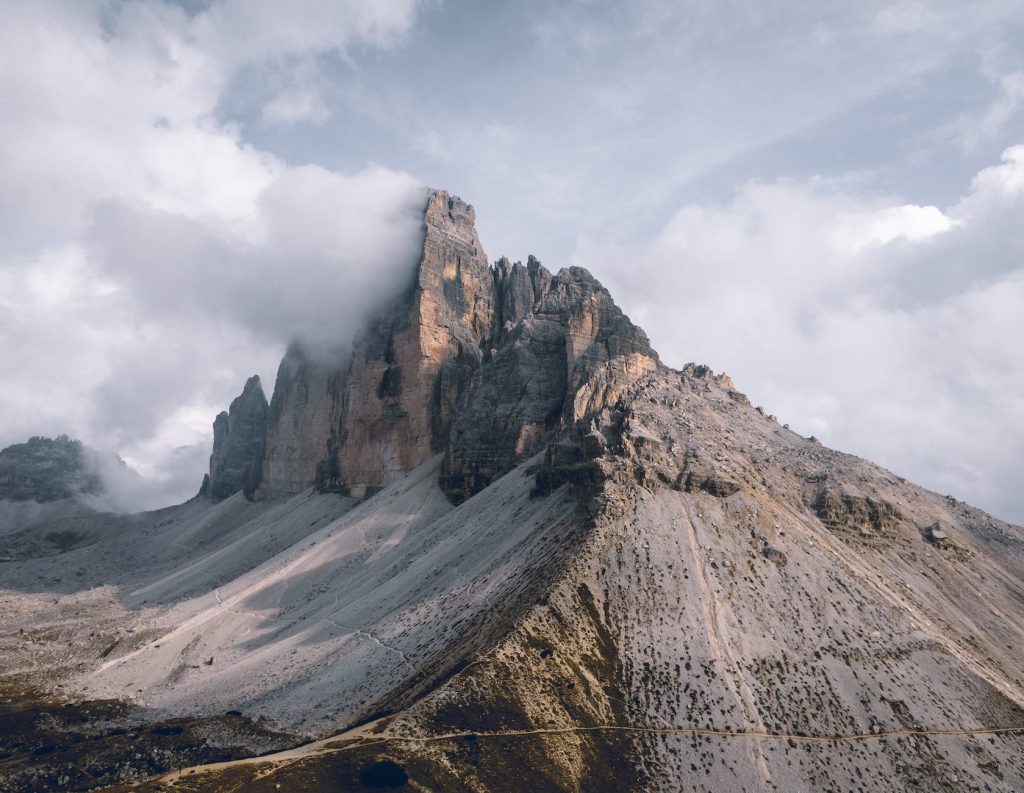 photo of mountains under cloudy sky